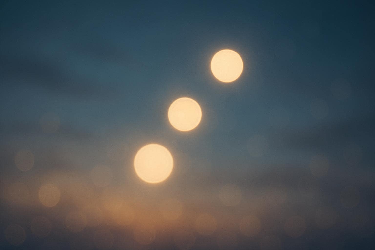 Three glowing orbs of light rising like a staircase against a twilight sky, symbolizing steady spiritual growth
